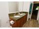 Bathroom with a dual sink vanity with a granite countertop and wood cabinets at 11522 Newport Dr, Indianapolis, IN 46236