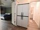 Bedroom with gray walls, wood-look floors, and adjacent bathroom at 11522 Newport Dr, Indianapolis, IN 46236
