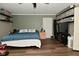 Bedroom with wood-look floors and blue bedding at 11522 Newport Dr, Indianapolis, IN 46236