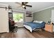 Bright bedroom featuring wood-look floors, neutral paint, and updated ceiling fan at 11522 Newport Dr, Indianapolis, IN 46236