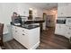 The kitchen features white cabinets, hardwood floors, and modern appliances at 11522 Newport Dr, Indianapolis, IN 46236