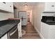 Bright kitchen featuring a gray countertop, stainless steel dishwasher, and wood-look floors at 11522 Newport Dr, Indianapolis, IN 46236