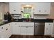 The kitchen features white cabinets, hardwood floors, and modern appliances at 11522 Newport Dr, Indianapolis, IN 46236