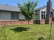 Back exterior view with brick and siding combination and a lush lawn offering a serene outdoor setting at 1165 Tewksbury Ct, Mooresville, IN 46158