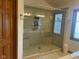 Elegant bathroom with glass-enclosed shower, tile walls and built-in seating at 1165 Tewksbury Ct, Mooresville, IN 46158