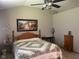 Inviting bedroom features a decorative painting, ceiling fan and furnishings at 1165 Tewksbury Ct, Mooresville, IN 46158