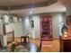 Open dining room with wood floors, chandelier, and lighted hutch at 1165 Tewksbury Ct, Mooresville, IN 46158