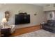 Bright living room with a large TV and hardwood flooring at 1165 Tewksbury Ct, Mooresville, IN 46158
