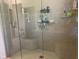 Walk-in shower featuring two built-in seats, modern fixtures, and tiled walls at 1165 Tewksbury Ct, Mooresville, IN 46158