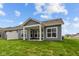 Exterior shot of the backyard featuring a covered patio area and well-kept lawn space at 12490 Morning Ridge Way, Noblesville, IN 46060