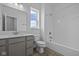 Well lit bathroom featuring a shower-tub, single sink vanity, and a window for natural light at 12490 Morning Ridge Way, Noblesville, IN 46060