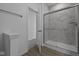 Bathroom with a glass shower door, marble tiling and an open doorway at 12490 Morning Ridge Way, Noblesville, IN 46060
