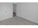 A bedroom with gray carpet, white walls and a pair of double doors to a closet at 12490 Morning Ridge Way, Noblesville, IN 46060