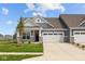 Charming home featuring a two-car garage, stone accents, and a well-maintained lawn, creating an inviting curb appeal at 12490 Morning Ridge Way, Noblesville, IN 46060