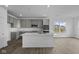 Modern kitchen with gray cabinets, stainless steel appliances, quartz countertops, and sleek finishes, offering a stylish cooking space at 12490 Morning Ridge Way, Noblesville, IN 46060