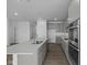 Spacious kitchen with gray cabinets, stainless steel appliances, and a large center island, ideal for cooking and entertaining at 12490 Morning Ridge Way, Noblesville, IN 46060