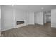 Spacious living room with modern finishes, recessed lighting, hardwood floors, and a cozy fireplace, offering a warm and inviting ambiance at 12490 Morning Ridge Way, Noblesville, IN 46060
