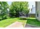 Spacious backyard featuring a trampoline, climbing dome, and a green lawn at 1252 Jasmine Dr, Greenfield, IN 46140