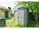 Backyard shed with closed doors, siding, and shingles on a green lawn at 1252 Jasmine Dr, Greenfield, IN 46140