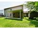 Backyard with a covered patio, shed, fire pit, sliding doors and a lush lawn at 1252 Jasmine Dr, Greenfield, IN 46140
