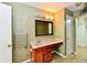 Bathroom featuring a wood vanity and modern sink, with an open doorway leading to a walk-in closet at 1252 Jasmine Dr, Greenfield, IN 46140