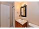 Bathroom with a vanity, toilet, and a mirror with decorative lighting at 1252 Jasmine Dr, Greenfield, IN 46140