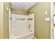 Brightly lit bathroom with white tiled shower and decorative accents at 1252 Jasmine Dr, Greenfield, IN 46140