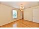 Bedroom with wood floors, a decorative light fixture, window, and a closet at 1252 Jasmine Dr, Greenfield, IN 46140
