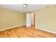 Spacious bedroom with wood floors, neutral walls, and an open doorway at 1252 Jasmine Dr, Greenfield, IN 46140