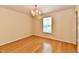 Bedroom with wood floors, a decorative light fixture, and a window at 1252 Jasmine Dr, Greenfield, IN 46140