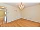 Dining room with wood floors, decorative light fixture, and access to another room at 1252 Jasmine Dr, Greenfield, IN 46140