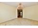 Empty dining room featuring tiled floor and chandelier, leading to rooms with hardwood flooring at 1252 Jasmine Dr, Greenfield, IN 46140