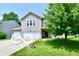 Well-maintained two-story home with a lush green lawn and mature trees at 1252 Jasmine Dr, Greenfield, IN 46140