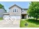 Charming two-story home with two-car garage and well-manicured lawn at 1252 Jasmine Dr, Greenfield, IN 46140