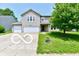 Charming two-story home with a well-maintained lawn, a two-car garage, and attractive landscaping at 1252 Jasmine Dr, Greenfield, IN 46140