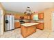 Updated kitchen featuring stainless steel appliances, an island, and oak cabinets at 1252 Jasmine Dr, Greenfield, IN 46140