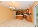 Open kitchen with oak cabinets, tile floors, a kitchen island, and sliding glass doors at 1252 Jasmine Dr, Greenfield, IN 46140