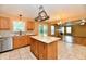 Open-concept kitchen featuring an island, oak cabinets, and stainless steel appliances, connecting to the living room at 1252 Jasmine Dr, Greenfield, IN 46140