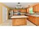 Well-equipped kitchen with oak cabinets, center island, stainless steel appliances, and mosaic backsplash at 1252 Jasmine Dr, Greenfield, IN 46140