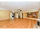 Spacious living room with hardwood floors, neutral walls, ceiling fan, and adjacent kitchen at 1252 Jasmine Dr, Greenfield, IN 46140