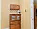 Close up on wall decor, including cabinets, a paper towel dispenser, and strawberry decor at 1252 Jasmine Dr, Greenfield, IN 46140