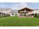 Expansive backyard with a covered patio featuring outdoor seating, perfect for entertaining at 12535 Old Pond Rd, Noblesville, IN 46060