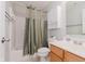 Well-lit bathroom featuring a shower-tub combo, modern vanity, and convenient storage cabinet at 12535 Old Pond Rd, Noblesville, IN 46060