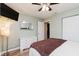 Comfortable bedroom with hardwood floors, fan, natural light, mounted TV and dresser at 12535 Old Pond Rd, Noblesville, IN 46060