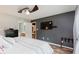 Bedroom with a dark gray accent wall, ceiling fan, and ensuite bathroom at 12535 Old Pond Rd, Noblesville, IN 46060