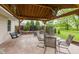 Relax on the covered patio with outdoor furniture and a swing, all in a private and landscaped backyard at 12535 Old Pond Rd, Noblesville, IN 46060