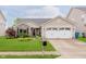 Charming home featuring well-maintained landscaping, a brick facade, and an attached two-car garage at 12535 Old Pond Rd, Noblesville, IN 46060