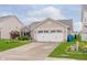 Two car attached garage with paved driveway and landscaping at 12535 Old Pond Rd, Noblesville, IN 46060