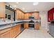 Another view of the kitchen features ample counter space and stainless steel appliances, perfect for cooking at 12535 Old Pond Rd, Noblesville, IN 46060
