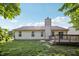 Backyard with a deck, lawn, and exterior of house with chimney at 12848 Patrick Ct, Fishers, IN 46038